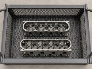 Heavy-duty immersion basket used to lower parts into a hot tank, securely holding components during the cleaning process while allowing full solution circulation.
