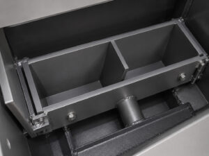Blast wheel inside a rebar blaster used to propel abrasive media at high velocity for cleaning reinforcing steel bars.