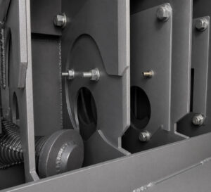 Interior view of a rebar blaster showing the blasting chamber, media flow components, and rebar transport path.