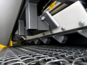 Optional movable blow-off and shot removal system on a concrete and scaffold blaster designed to remove residual abrasive media from parts after blasting.