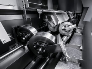 Conveyor wheels inside an interior pipe blaster used to support, guide, and transport pipes during internal abrasive blasting.