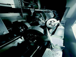 Conveyor wheels in a pipe blaster used to support, rotate, and transport pipes through the abrasive blasting system.
