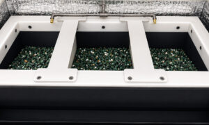 Optional divider system inside a vibratory tub finishing machine creating multiple processing sections for different media types, part families, or finishing operations.