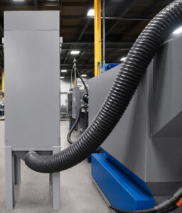 Dust collector connected to a tumbler blaster designed to capture dust, abrasive fines, and contaminants generated during the blasting process.
