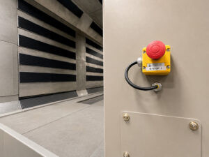 Emergency stop button mounted on an infrared cure oven, providing operators with immediate shutdown capability for enhanced safety and equipment protection.