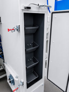 Abrasive elevator system on a flow-through drum blaster that lifts recovered shot media and returns it to the blasting system for continuous operation.