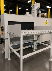 Entrance ramp of a flow-through cylinder polisher used to guide cylinders smoothly into the polishing system for automated surface finishing.