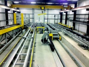Fully automated pipe blaster system with integrated handling, conveyor, blasting, and control components for continuous pipe surface preparation.