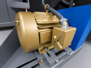 Heavy-duty impeller motor mounted on a tumbler blaster providing power to the blast wheel system for abrasive cleaning and surface preparation operations.