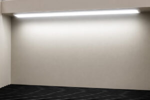 Integrated overhead light above a downdraft table providing bright illumination of the work surface for improved visibility during fabrication and finishing operations.