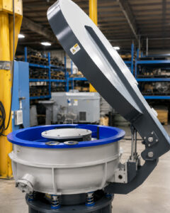 Optional lid installed on a vibratory bowl finishing system, designed to reduce noise, contain media and parts, and improve operational safety.