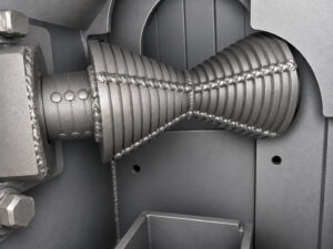 Rollers inside a rebar blaster used to support, align, and transport reinforcing steel bars through the blasting chamber.