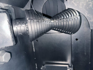 Rollers inside a rebar blaster used to support and guide reinforcing steel bars through the blasting chamber.