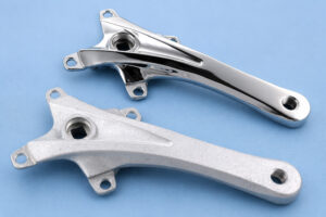 Side-by-side comparison of sample parts before and after processing in a vibratory tub with aluminum media, showing improved surface finish, cleaning, and deburring results.