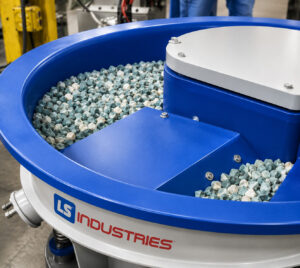 Wide view of a self-sort ramp on a vibratory bowl finishing system automatically separating finished parts from the media during operation.