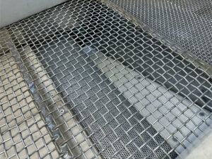 Discharge ramp on a vibratory separator where finishing media exits the system during part and media separation.