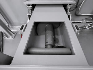 Shot loader and auger system on a slat blaster designed to recover, transport, and replenish abrasive media for continuous blasting operations.