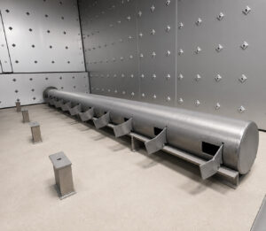 Interior view of a walk-in burn-off oven highlighting the integrated part support slots designed to hold racks, fixtures, and components during the thermal cleaning process.