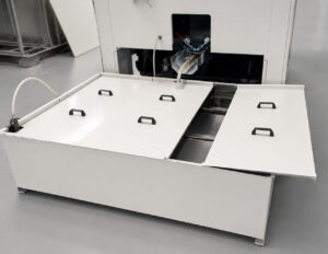 Optional compound tank mounted on a vibratory tub finishing system used to store and deliver water, finishing compounds, and process additives during operation.