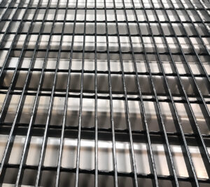 Close-up view of the workstation area on a downdraft table showing the perforated work surface where dust, smoke, and debris are captured directly at the source.