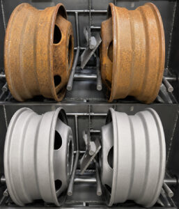 Side-by-side comparison of wheel rims before and after processing through a wheel rim blaster, showing the removal of rust, paint, scale, and surface contaminants.