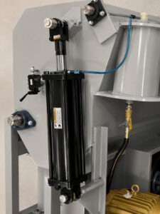 Optional pneumatic door system on a wheel rim blaster providing automated opening and closing of the blast chamber for efficient loading and unloading operations.