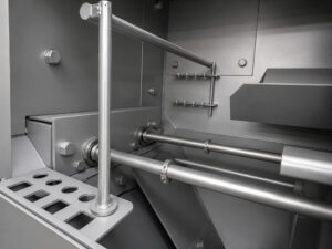 Adjustable diverter inside a wheel rim blaster designed to direct abrasive media and optimize blast coverage for different wheel and rim sizes.