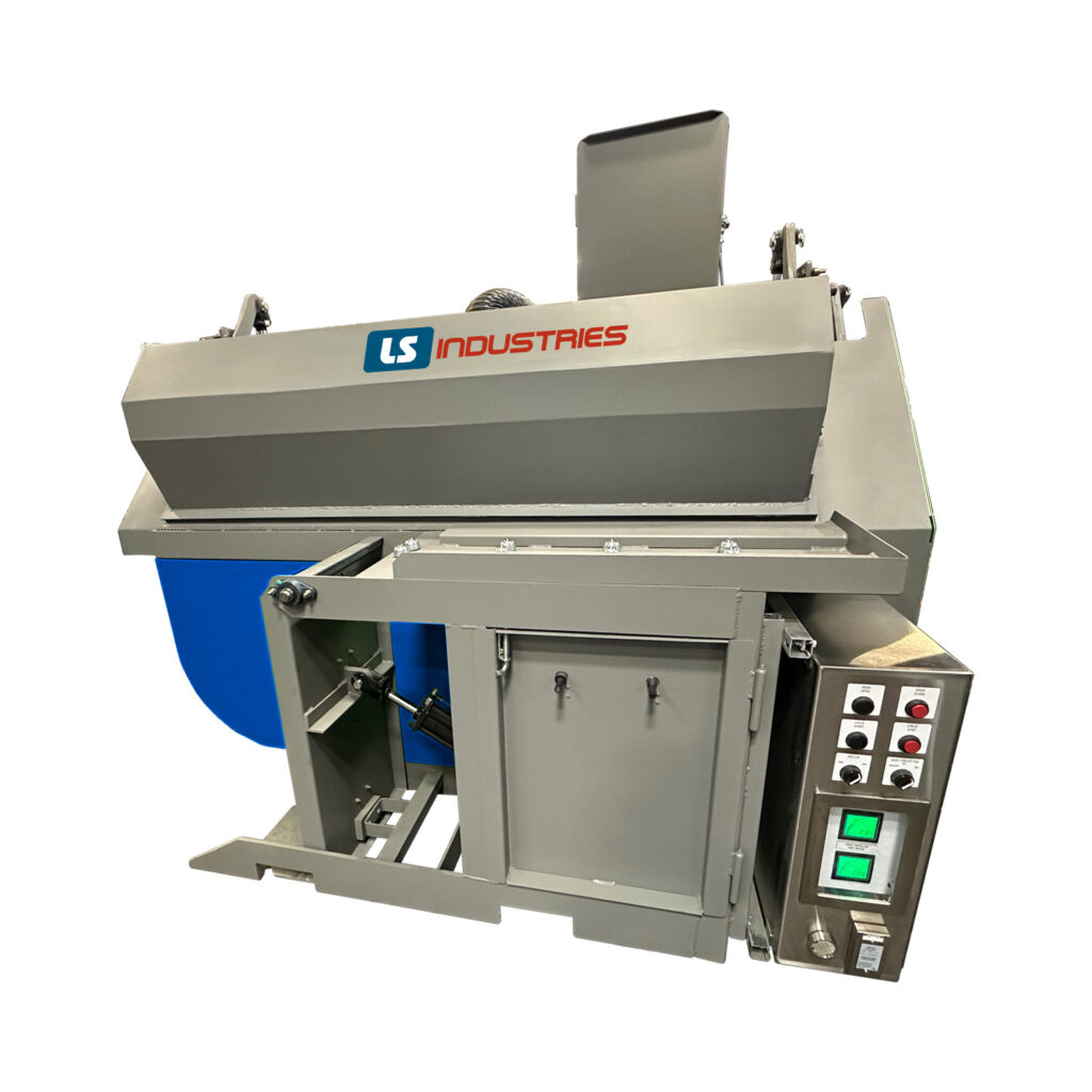Angled view of a batch cylinder blaster used for abrasive cleaning and surface preparation of cylindrical components in batch processing.
