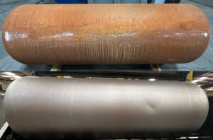 Side-by-side comparison of a cylinder before and after abrasive blasting, showing removal of rust, scale, and surface contaminants.