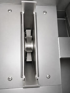 High-performance blast wheel mounted on a table blaster used to propel abrasive media at high velocity for cleaning and surface preparation of industrial parts.