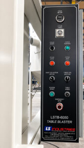 Control panel of a table blaster featuring machine controls, operating functions, and system monitoring for abrasive blasting operations.