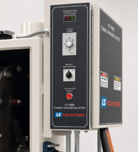 Industrial control panel of a tumble washer featuring cycle controls, timers, status indicators, and machine controls used to manage automated cleaning operations.