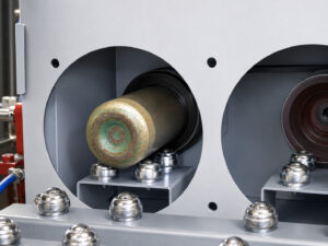Cylinders positioned inside the blast chamber of an IDB-2 Interior Cylinder Blaster as the interior blasting process cleans and prepares the inside surfaces.