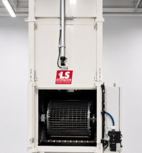 Optional air-operated vertical lift door on a tumble washer providing automated opening and closing for faster loading, unloading, and safer operation.