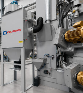 Dust collector and shot adder system connected to a table blaster, providing dust removal and automatic abrasive replenishment for efficient blasting operations.