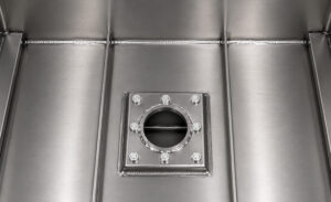 Fill and drain system on a dip tank featuring fluid inlet and discharge connections used to add, remove, and manage cleaning solutions within the tank.