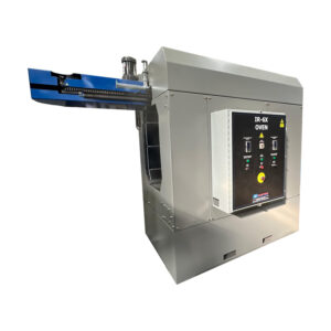 Angled view of an IR-6X infrared oven showing the full industrial heating system, including enclosure, monorail transport system, and structural design for thermal processing.