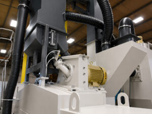 Heavy-duty impeller motor on a flow-through cylinder blaster used to power the blast wheel and propel abrasive media during cylinder cleaning operations.