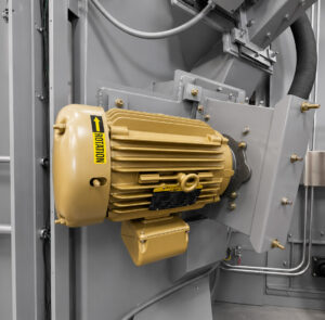 Heavy-duty impeller motor mounted on a table blaster providing power to the blast wheel system for abrasive blasting operations.