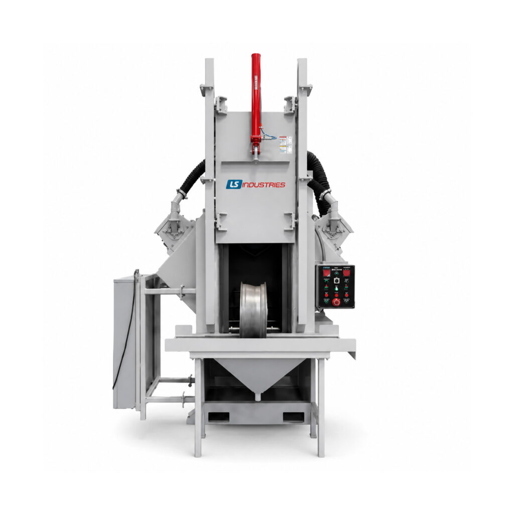 Front view of a wheel rim blaster showing the blast cabinet, loading area, wheel handling system, and integrated blasting components.