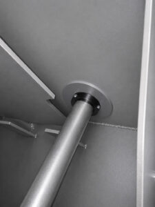 Heavy-duty rollers inside a batch drum blaster used to support and rotate steel drums during the abrasive blasting process.