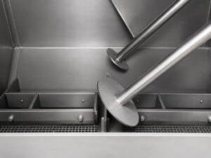 Interior bottom section of a batch drum blaster showing the drum support stoppers and mounting system that securely holds drums in position during blasting.