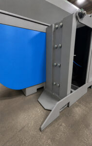 Upender system used to lift cylinders onto loading rollers for transfer into a cylinder blaster.