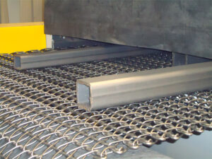 Close-up view of industrial chain belt conveyors used for transporting heavy parts and materials in automated handling systems.