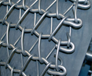 Close-up view of industrial chain belt conveyors used for transporting heavy parts and materials in automated handling systems.