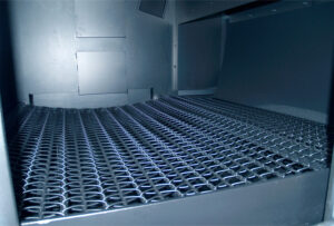 Close-up view of industrial chain belt conveyors used for transporting heavy parts and materials in automated handling systems.