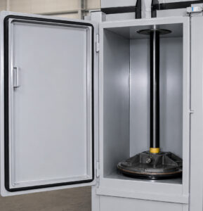 Fully crushed steel drum inside a drum crusher, compressed into a compact form to reduce storage space and improve recycling efficiency.