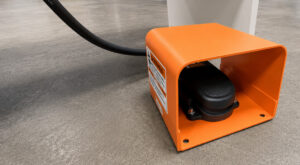 Foot pedal control of a platen surface grinder allowing hands-free operation of machine functions for improved precision, safety, and operator efficiency.