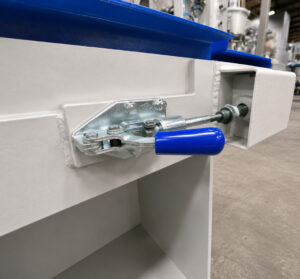 Control switch for the removable grinding belt on a platen surface grinder, allowing operators to safely engage, disengage, and replace the grinding belt during operation and maintenance.