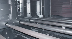 Close-up view of industrial roller conveyors used for transporting parts and materials through automated production and handling systems.